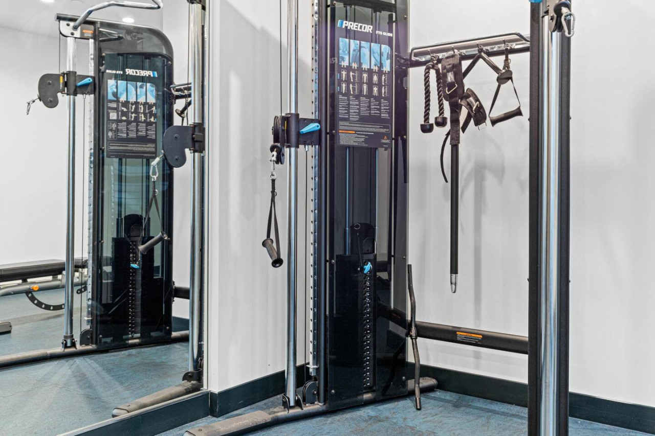 Open floor area with exercise mats, yoga balls, and foam rollers for warm-ups, stretching, or core exercises.