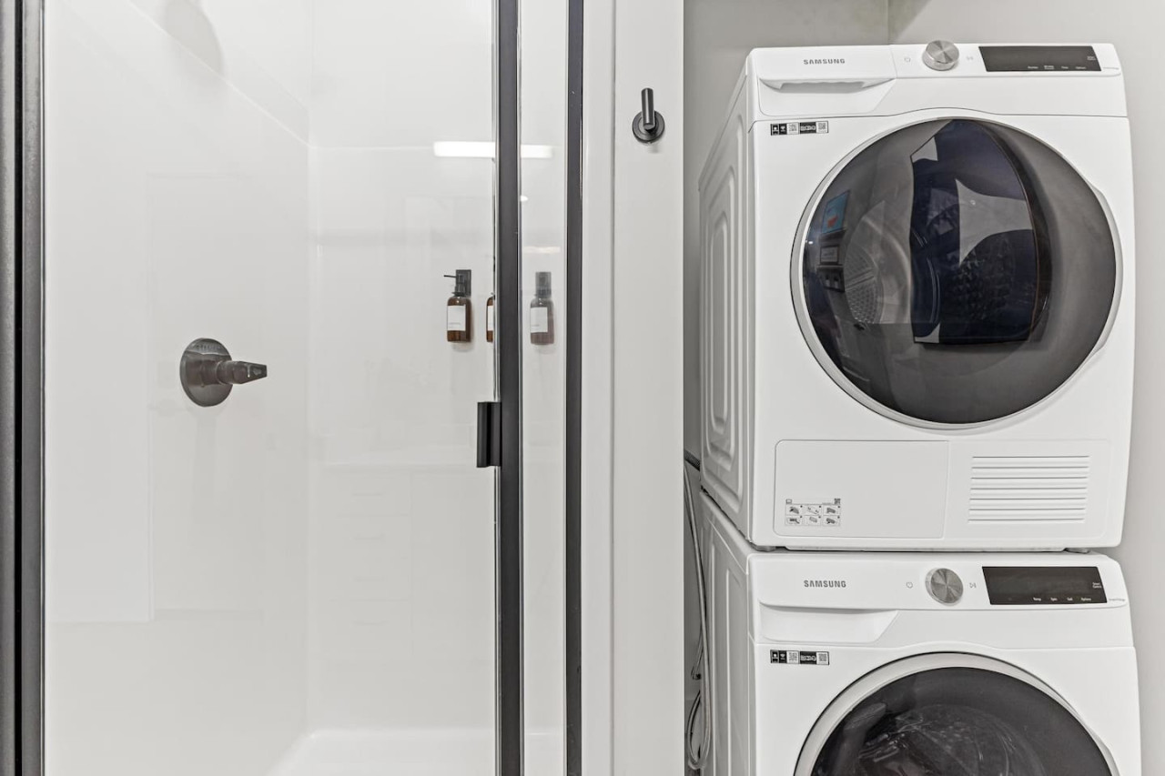 As you step into the laundry room, the modern appliances and ample storage space make it easy to keep things tidy.