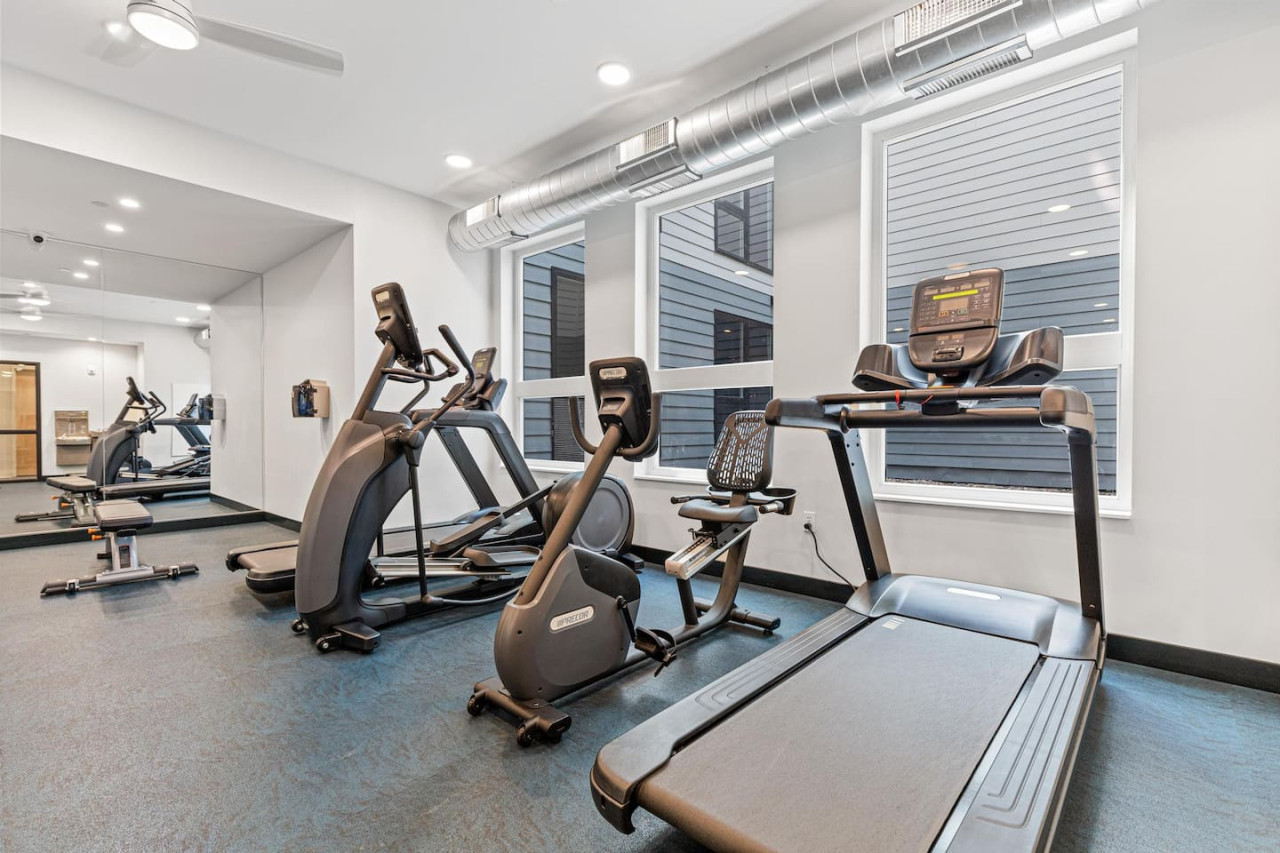 Open floor area with exercise mats, yoga balls, and foam rollers for warm-ups, stretching, or core exercises.