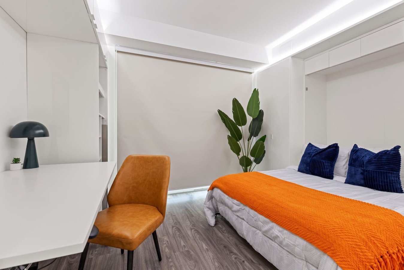 Luxurious queen bedroom featuring a comfortable bed, elegant decor, and plenty of natural light for a rejuvenating sleep.