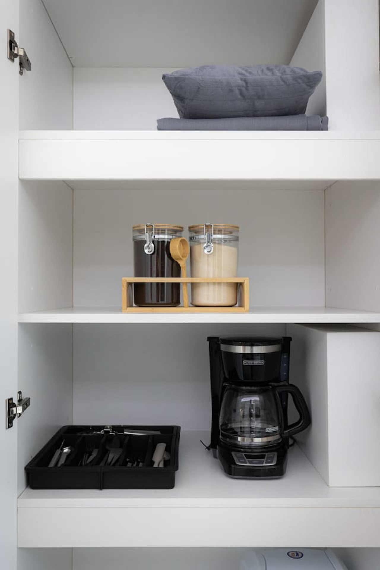 Kitchen cabinets stocked with cooking wares, glassware and silverwares, ideal for mixing up your favorite meals and drinks during your stay.