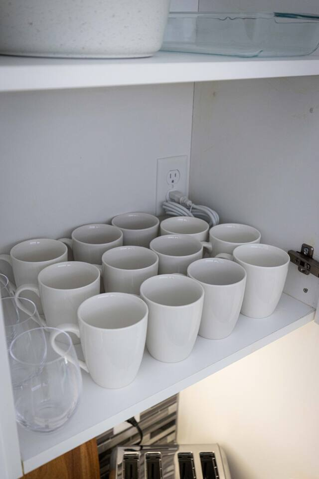 Kitchen cabinets stocked with cooking wares, glassware and silverwares, ideal for mixing up your favorite meals and drinks during your stay.