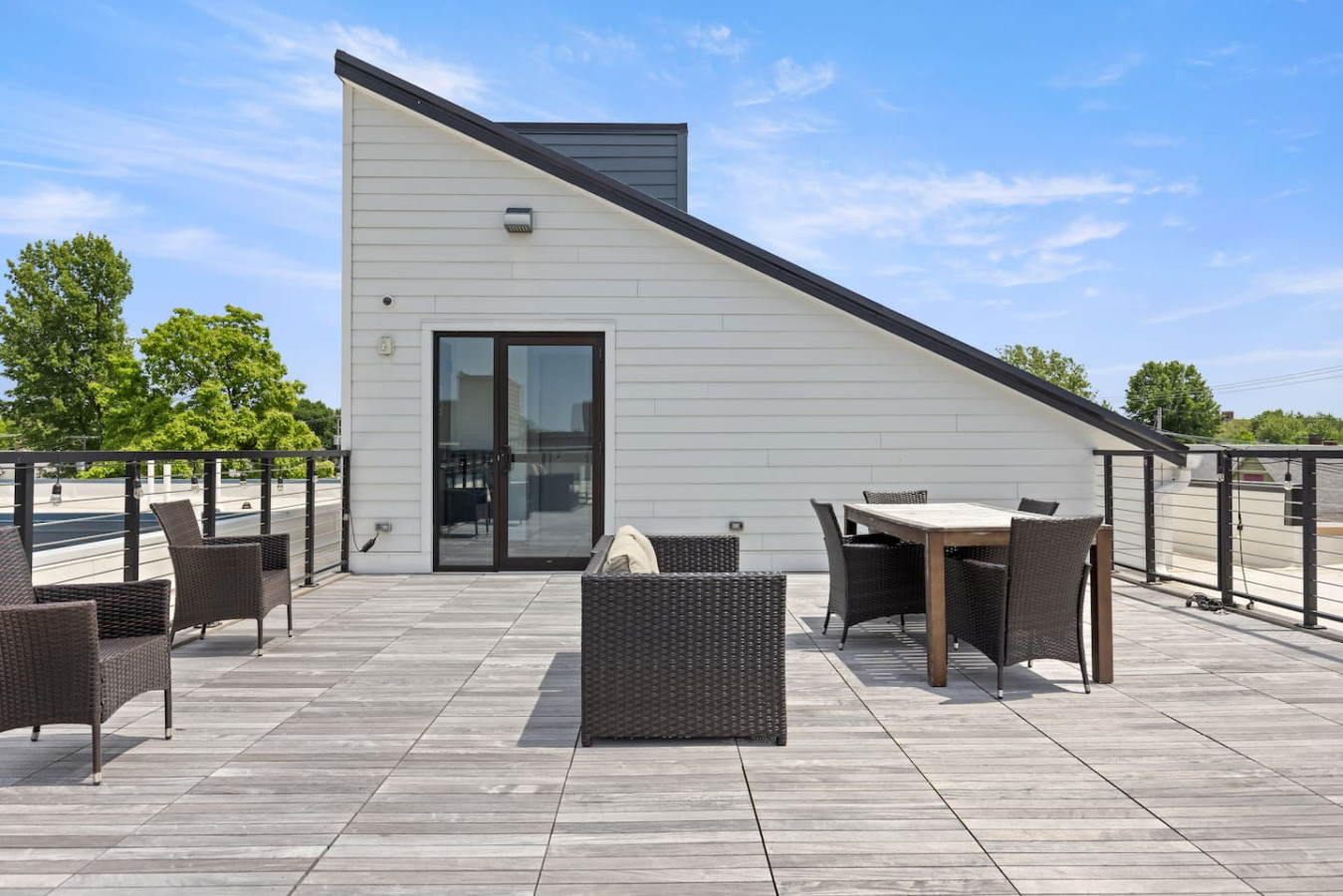 The house’s exterior is a blend of modern and classic design elements, creating a welcoming and stylish facade.