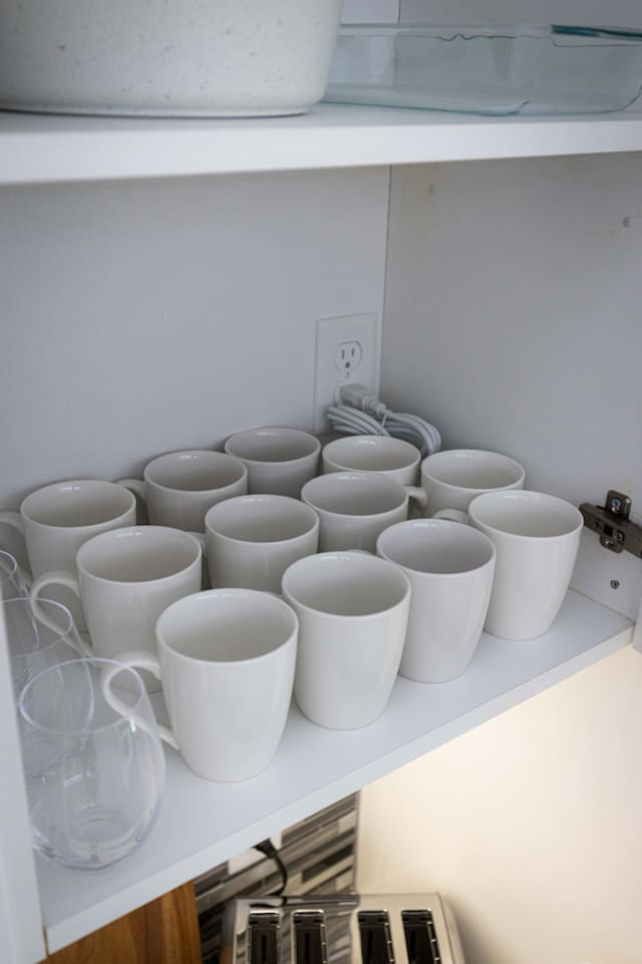 Kitchen cabinets stocked with cooking wares, glassware and silverwares, ideal for mixing up your favorite meals and drinks during your stay.