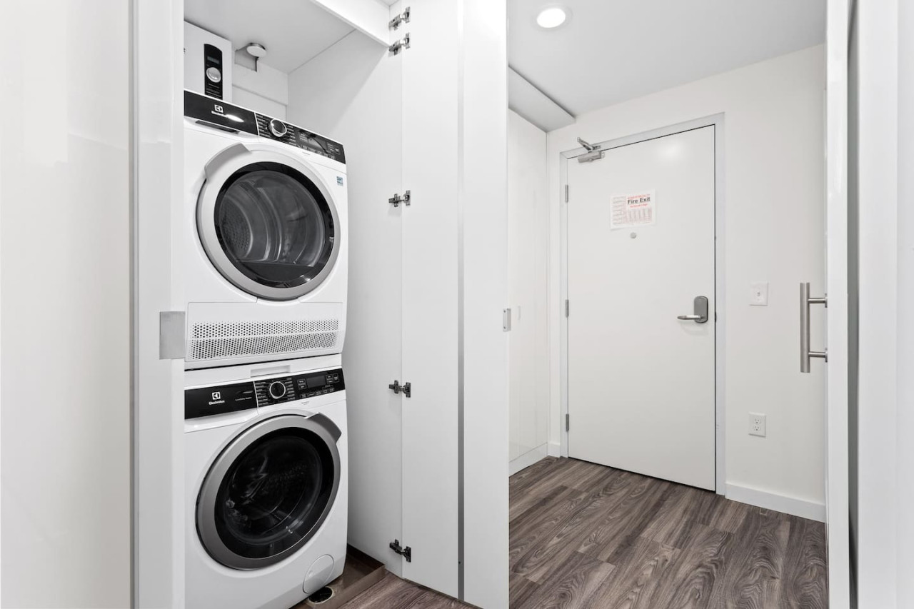 As you step into the laundry room, the modern appliances and ample storage space make it easy to keep things tidy.