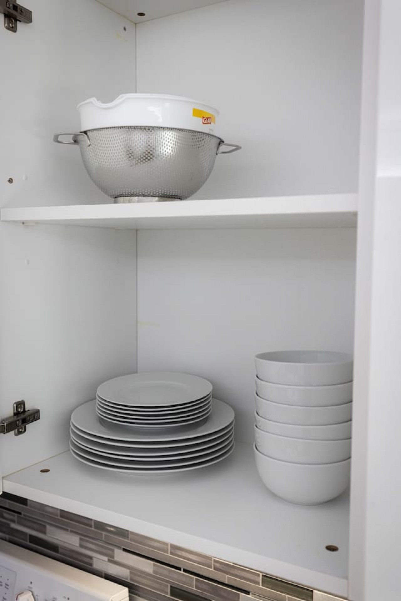 Kitchen cabinets stocked with cooking wares, glassware and silverwares, ideal for mixing up your favorite meals and drinks during your stay.