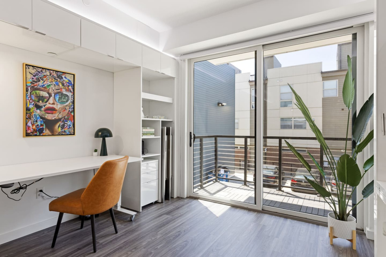 This cozy workspace in the master bedroom is perfect for productivity. Enjoy natural light, a comfortable chair, and a stylish desk setup. Ideal for work-from-home needs or planning your Dallas adventures.