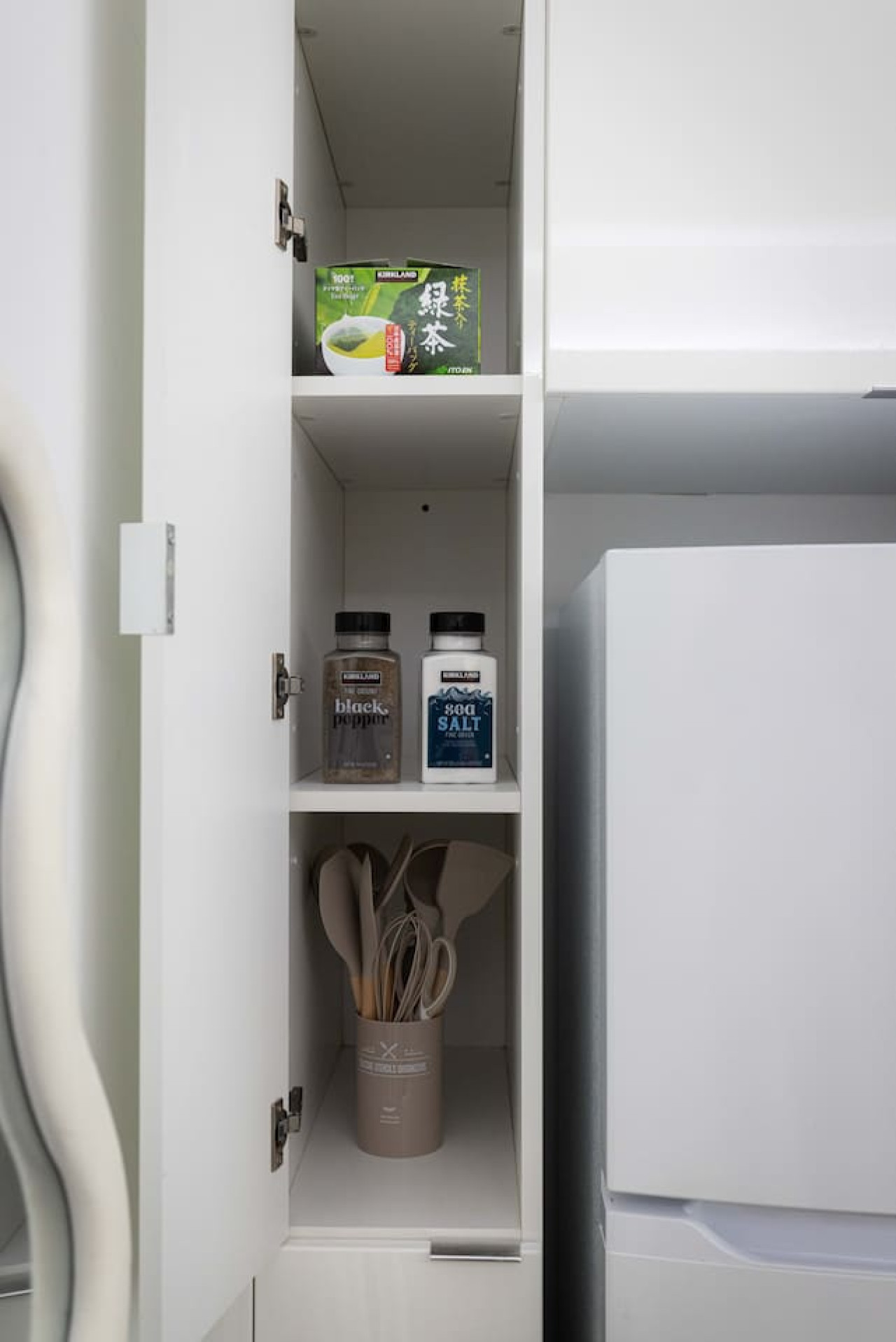 Kitchen cabinets stocked with cooking wares, glassware and silverwares, ideal for mixing up your favorite meals and drinks during your stay.