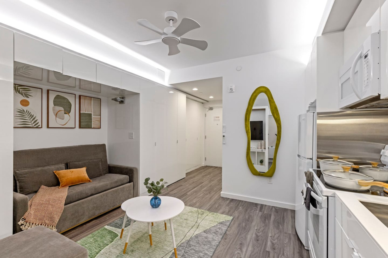 Spacious open-concept area featuring a modern furnishings, and a stylish entertainment setup—ideal for gatherings and relaxation.