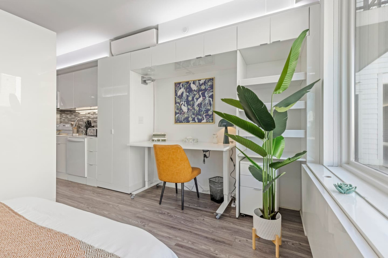 This cozy workspace with warm lighting, and a creative wall display, perfect for productivity.
