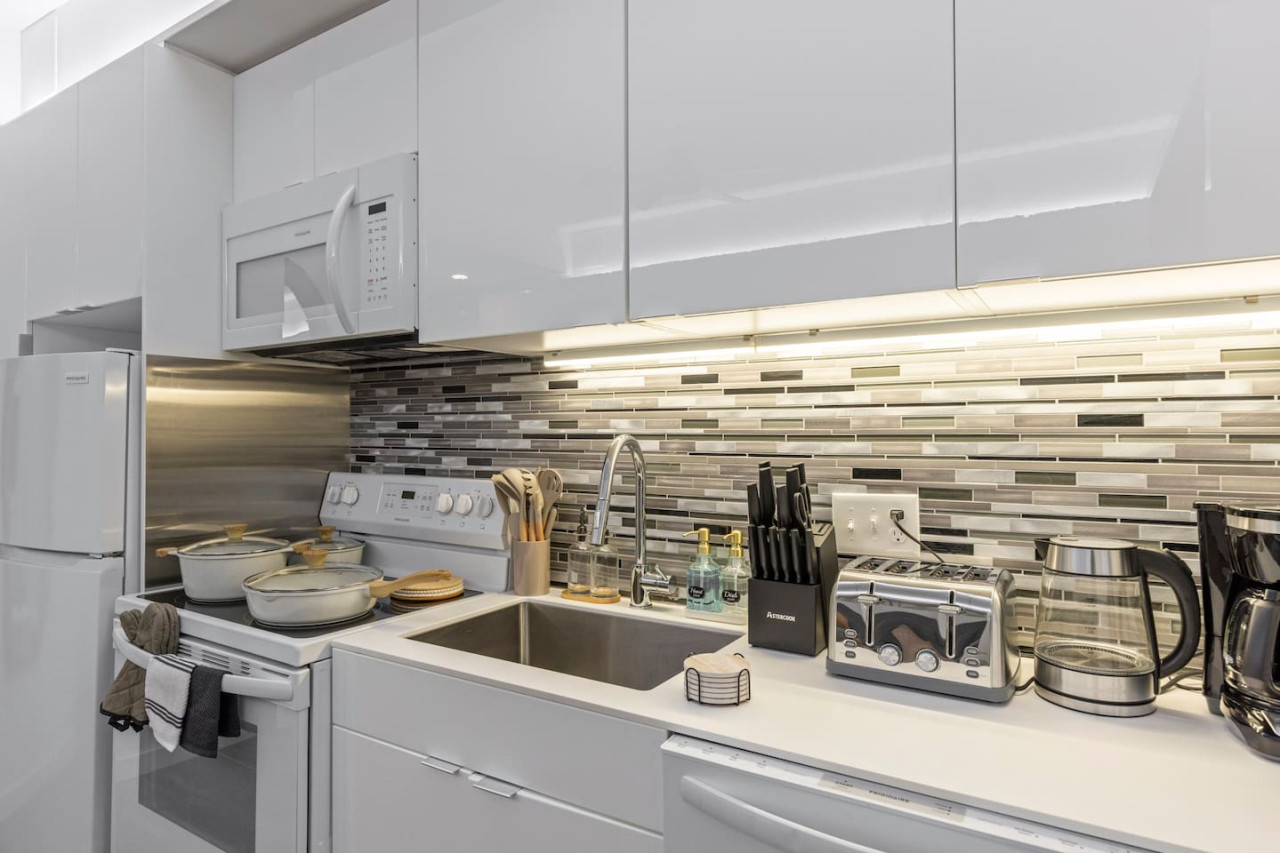 The kitchen invites you to experiment with new recipes, offering a stylish and practical space to cook and create.