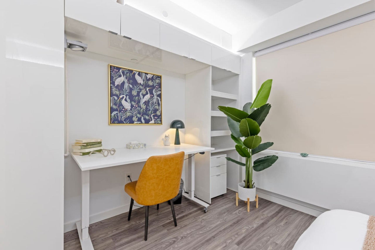 This cozy workspace in the master bedroom is perfect for productivity. Enjoy natural light, a comfortable chair, and a stylish desk setup. Ideal for work-from-home needs or planning your Dallas adventures.