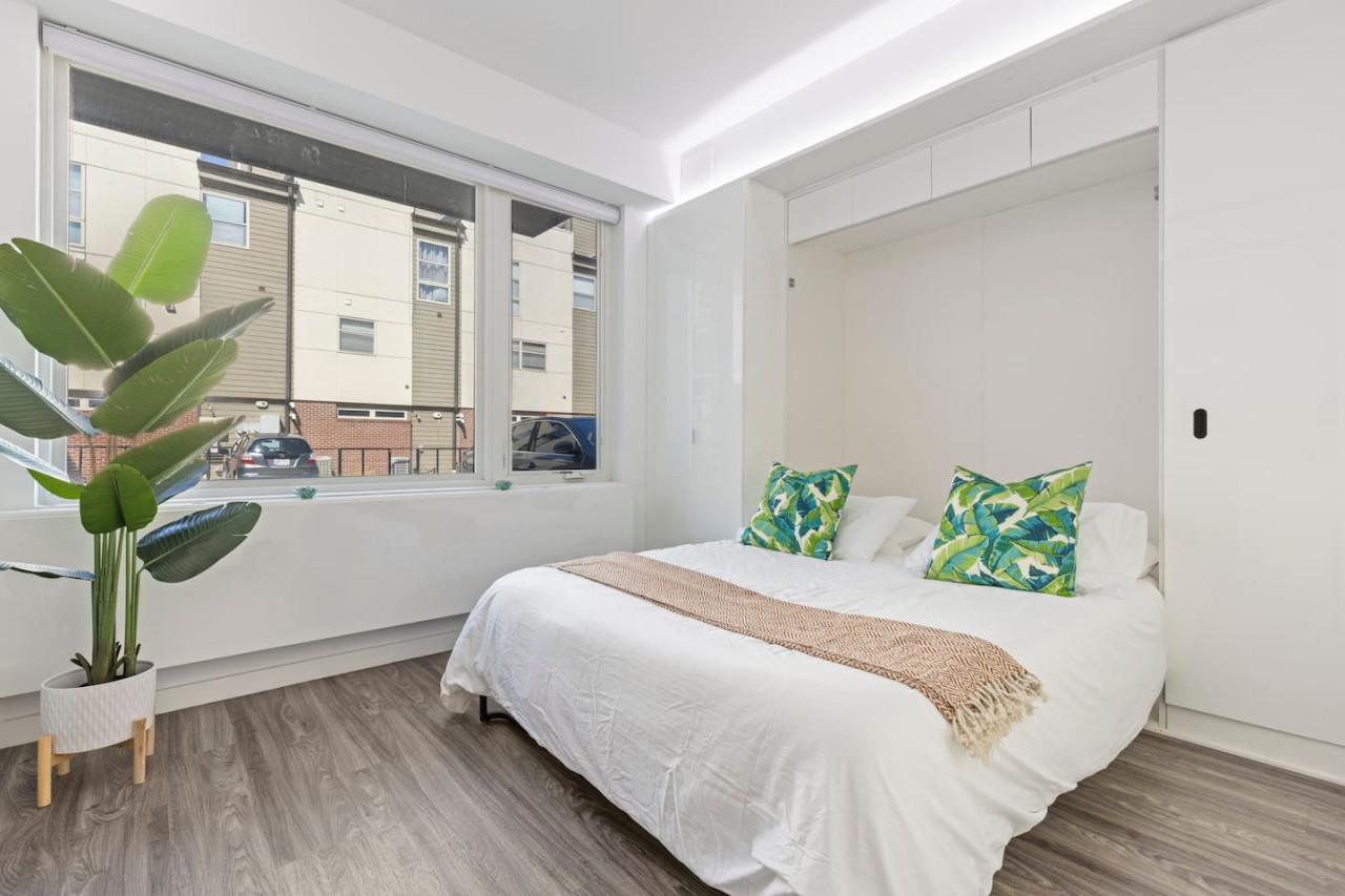 You feel enveloped in comfort as you relax on the queen bed, surrounded by a room designed for tranquility.