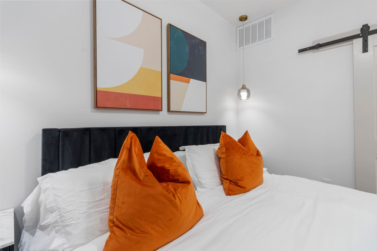 You feel enveloped in comfort as you relax on the queen bed, surrounded by a room designed for tranquility.