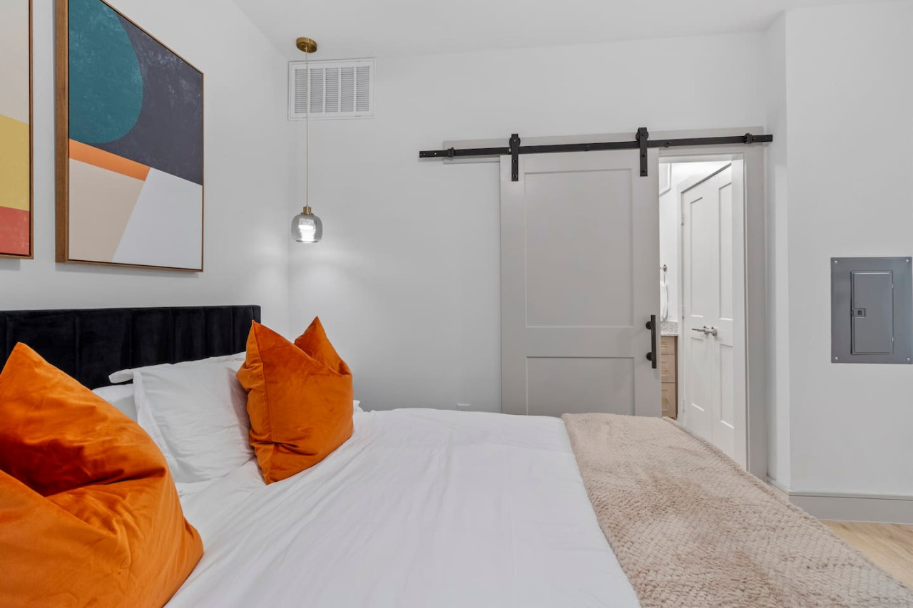 You feel enveloped in comfort as you relax on the queen bed, surrounded by a room designed for tranquility.