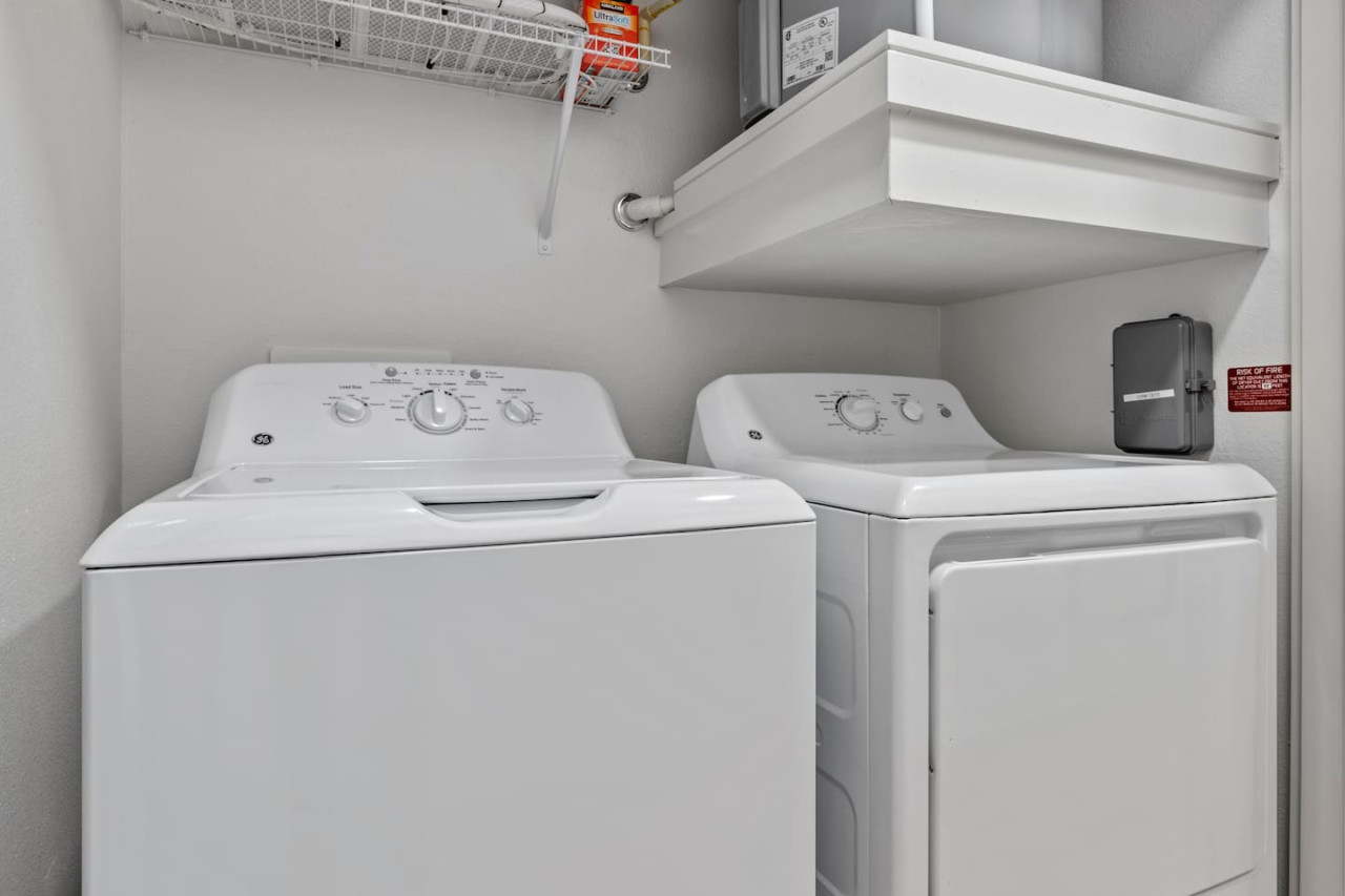 As you step into the laundry room, the modern appliances and ample storage space make it easy to keep things tidy.