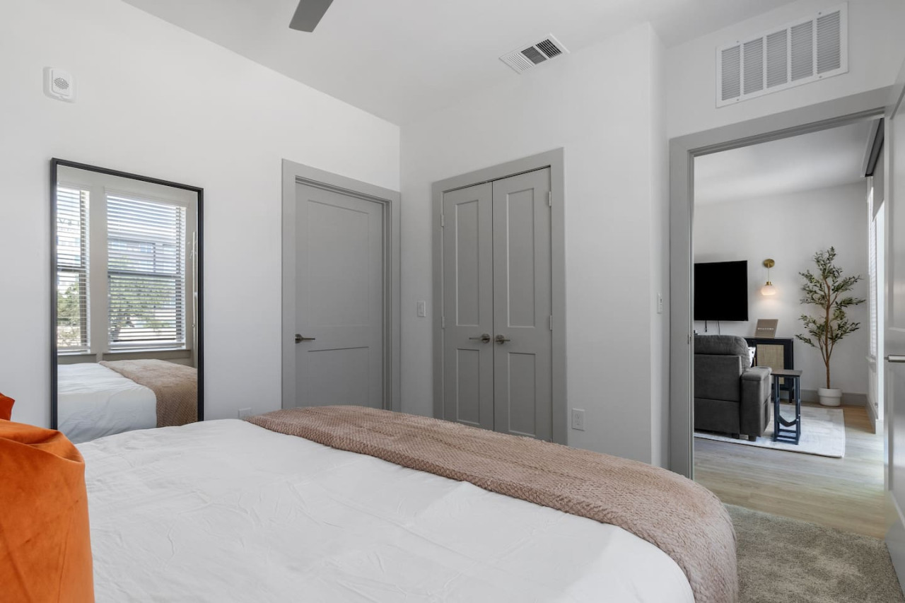 The bedroom offers a luxurious retreat, with a bed that promises restful nights and a room that feels like a private oasis.
