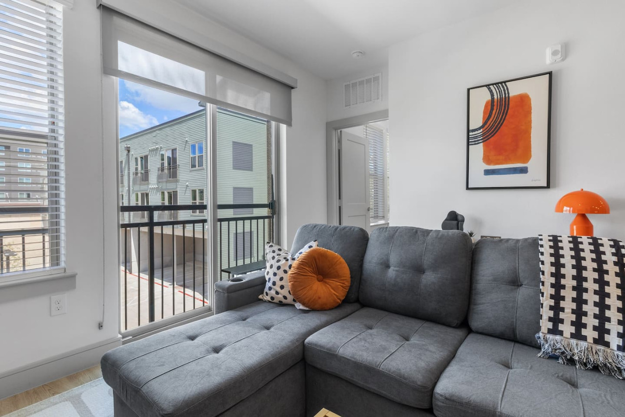 The living room is filled with natural light, creating a bright and welcoming space that invites relaxation.