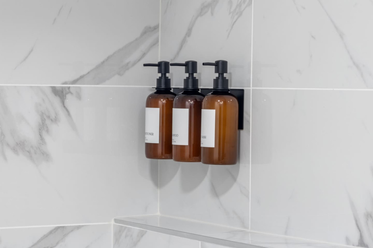 Immaculate bathroom featuring a spacious shower, fresh towels, and complimentary toiletries for a spa-like experience.