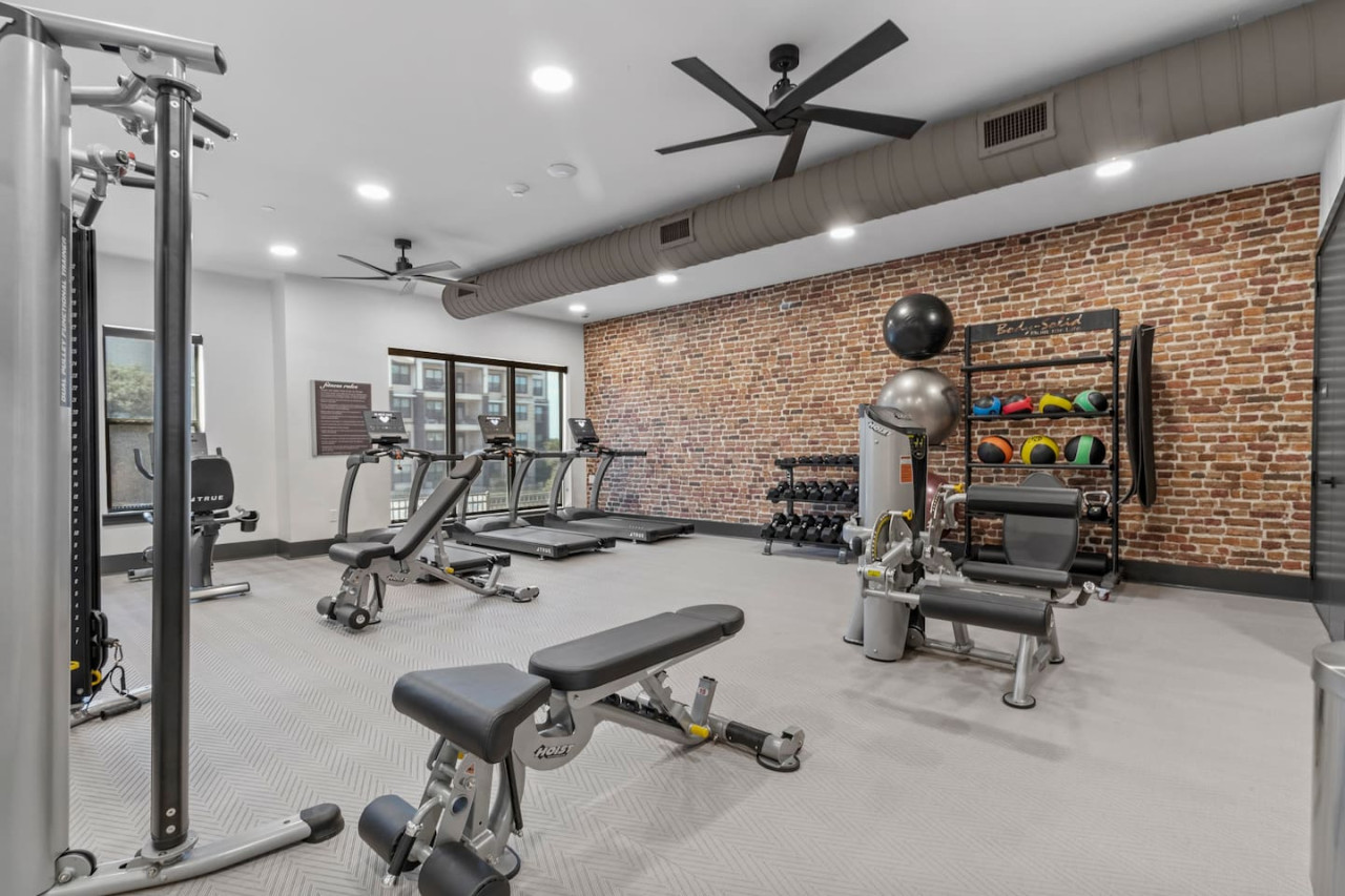 Dedicated space featuring a wide range of dumbbells, benches, and mirrors for strength and resistance training