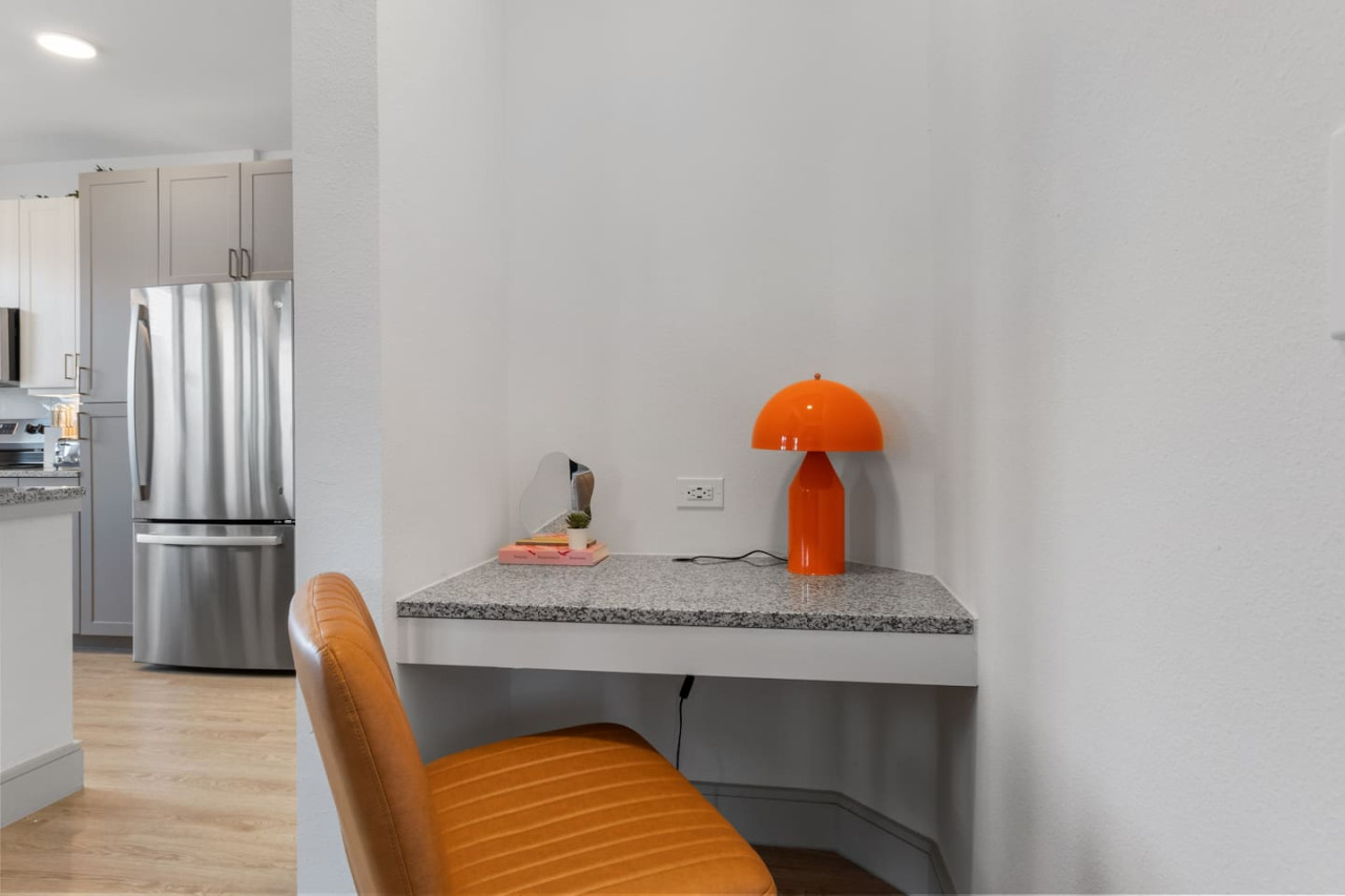 This cozy workspace with warm lighting, and a creative wall display, perfect for productivity.