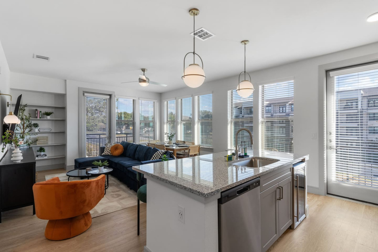 As you approach the home bar, the elegant layout and well-stocked shelves make it the ideal spot to relax.
