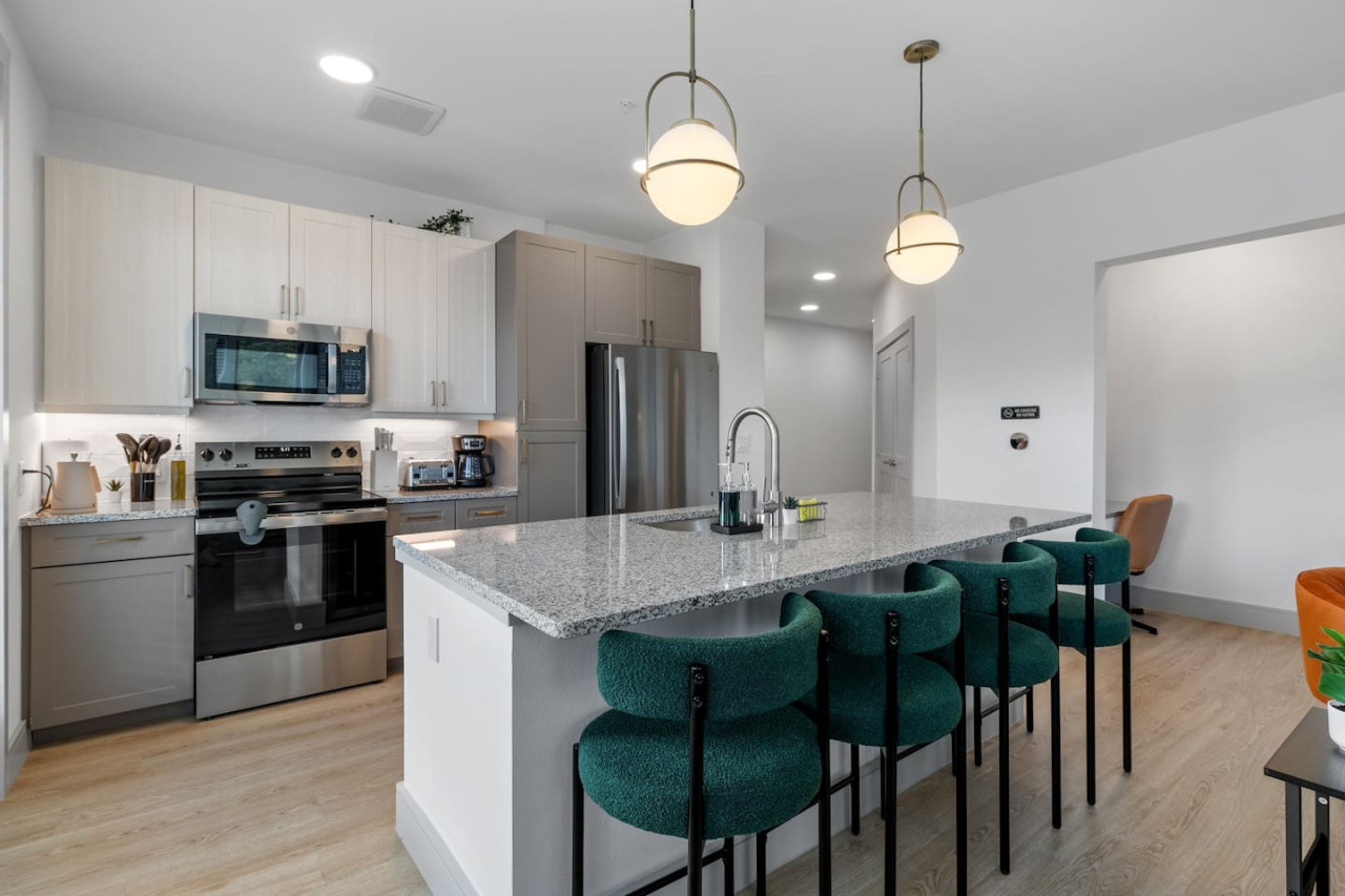 As you approach the home bar, the elegant layout and well-stocked shelves make it the ideal spot to relax.