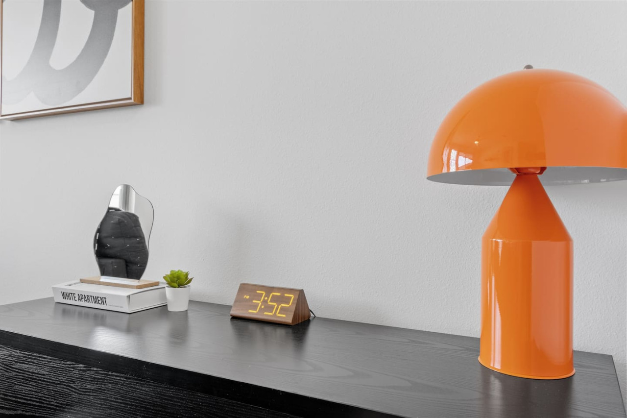 This cozy workspace with warm lighting, and a creative wall display, perfect for productivity.