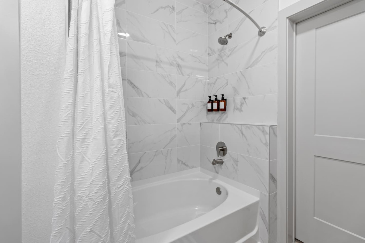 You feel a sense of calm as you enter the bathroom, where the thoughtful design and high-quality materials create a serene environment.