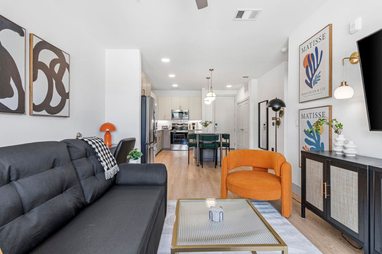 You feel a sense of peace as you step into the living room , with its inviting decor and soothing tones.