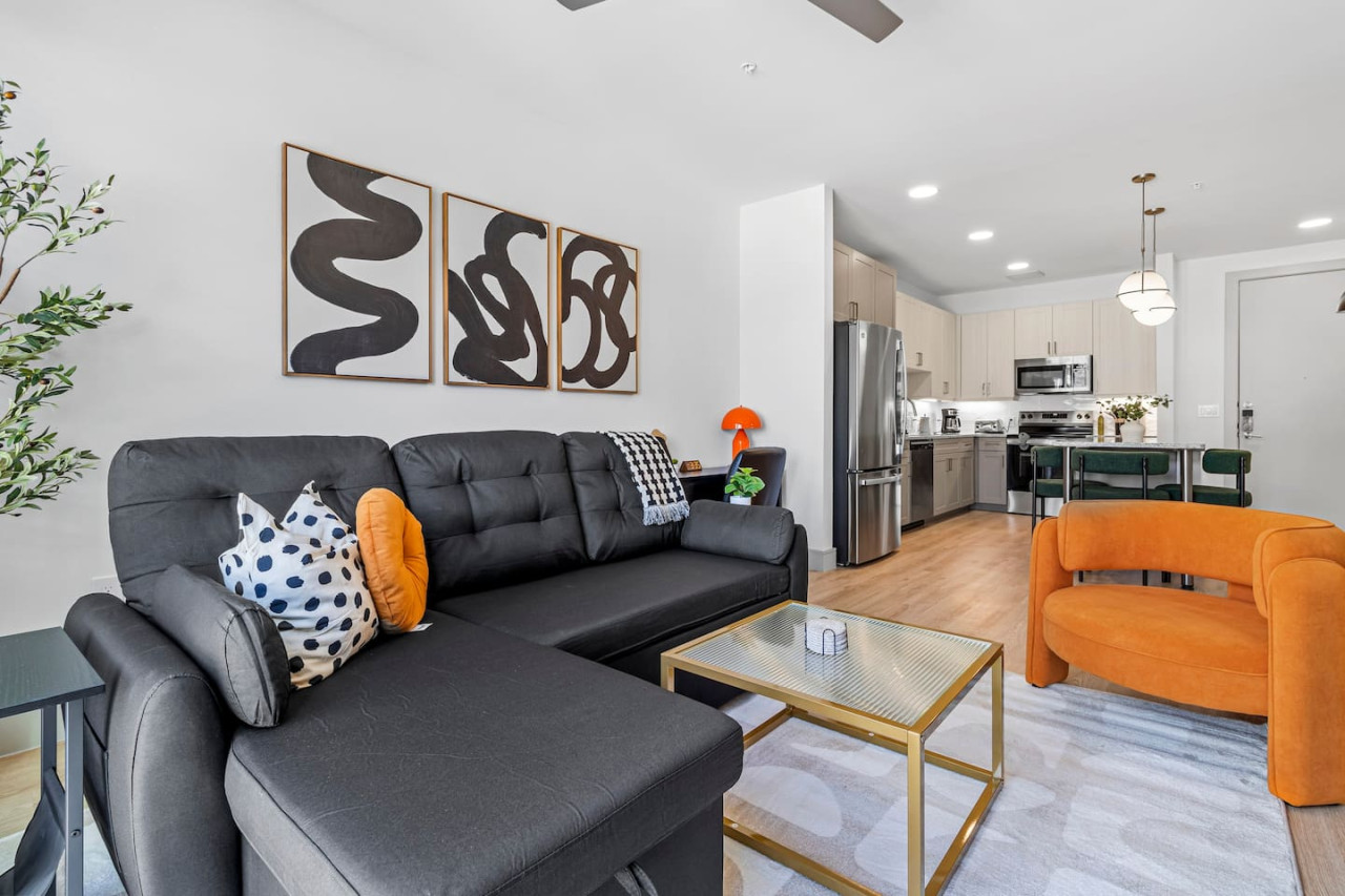 You feel a sense of peace as you step into the living room , with its inviting decor and soothing tones.
