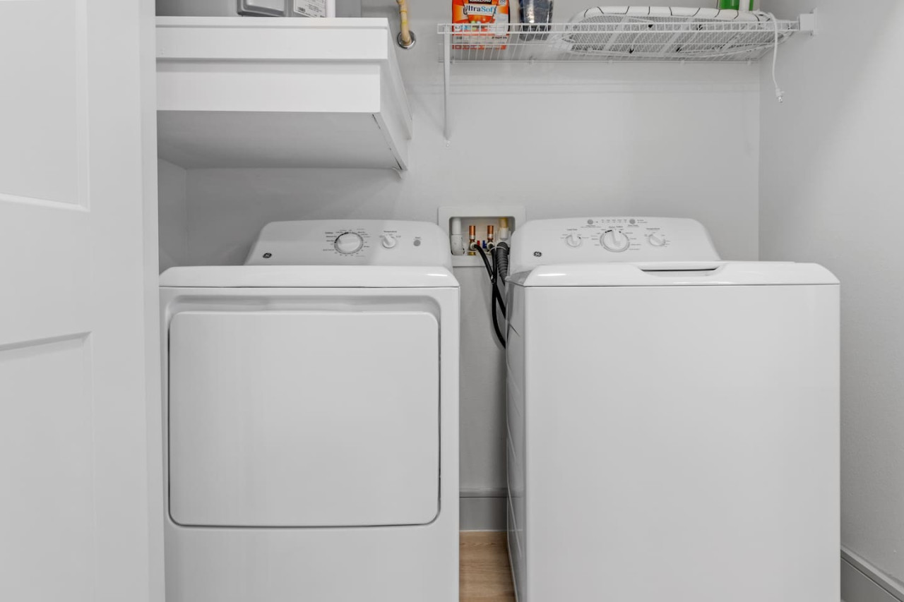 As you step into the laundry room, the modern appliances and ample storage space make it easy to keep things tidy.