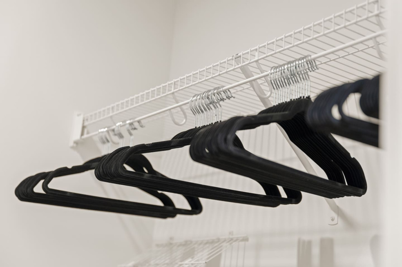 Modern built-in closets with hangers and shelving, perfect for keeping your clothes organized during your stay.