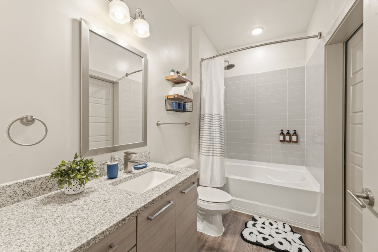 You feel a sense of calm as you enter the bathroom, where the thoughtful design and high-quality materials create a serene environment.