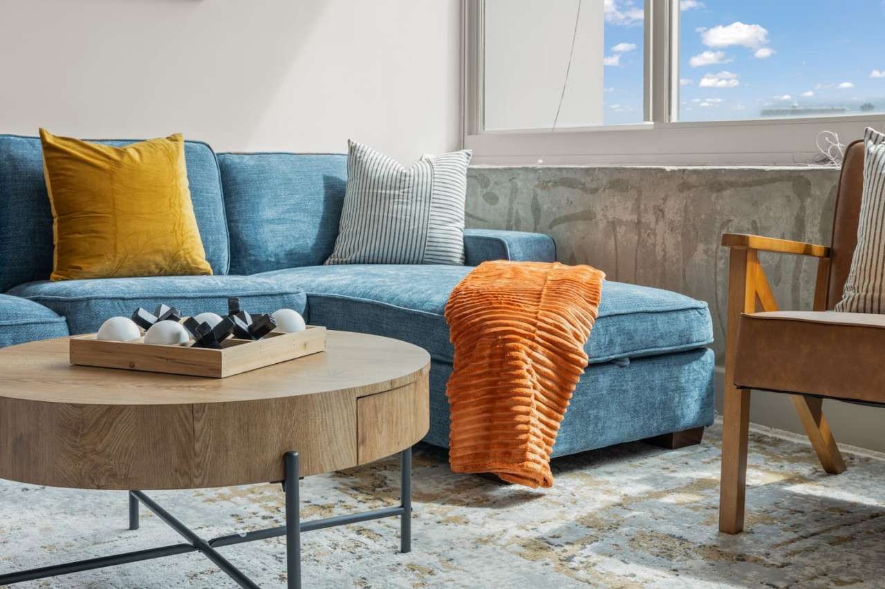 Bright and airy living room with plush seating, a large TV, and tasteful decor, creating the perfect space for relaxation and entertainment.
