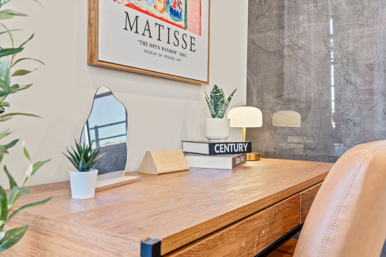 This cozy workspace in the master bedroom is perfect for productivity. Enjoy natural light, a comfortable chair, and a stylish desk setup. Ideal for work-from-home needs or planning your Dallas adventures.