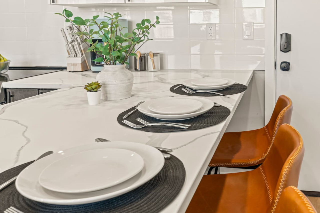 Set the table for memorable meals in this beautifully arranged dining area. With elegant place settings and a charming centerpiece, it's perfect for hosting dinner parties or enjoying family dinners in a cozy and stylish atmosphere.