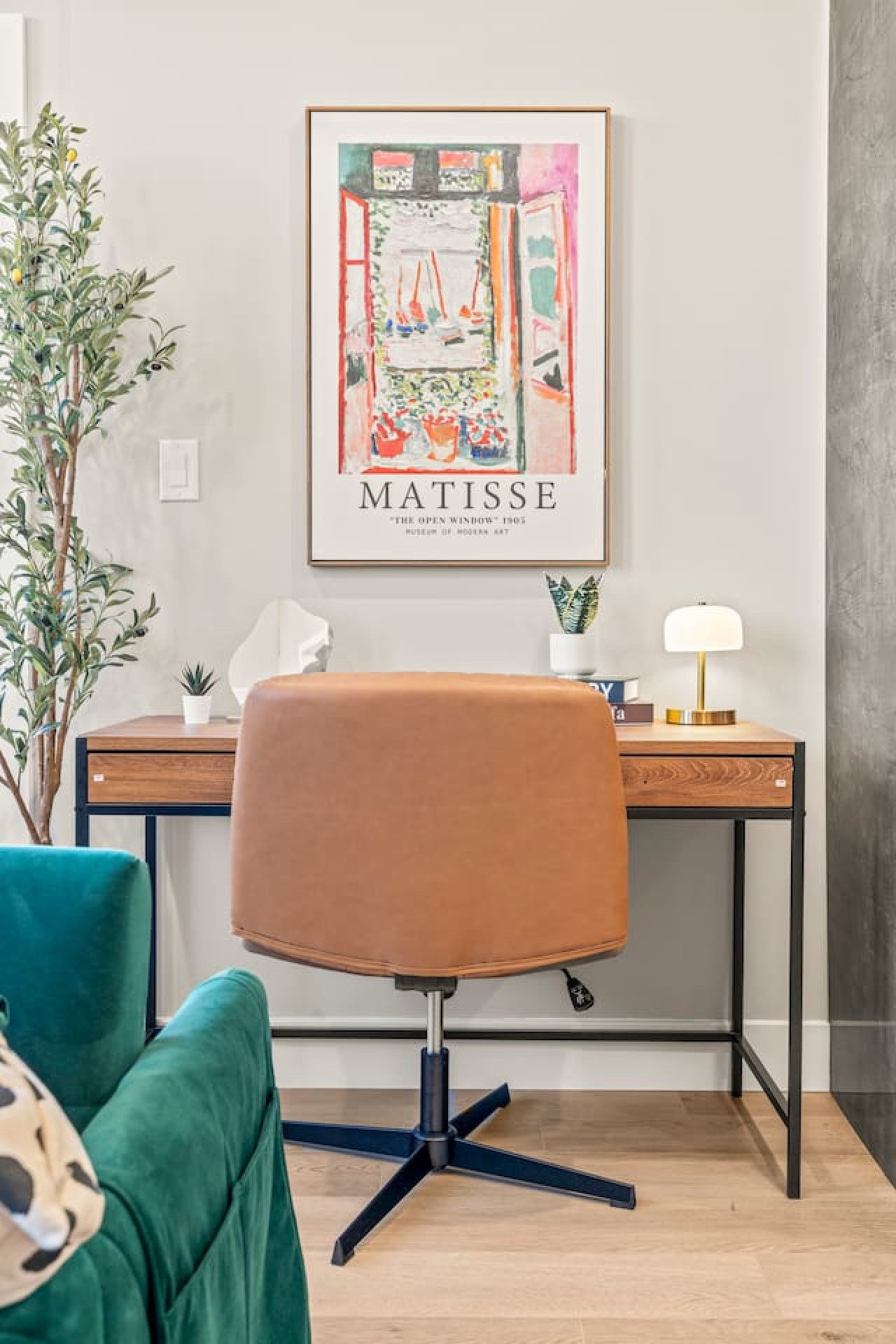 This cozy workspace with warm lighting, and a creative wall display, perfect for productivity.