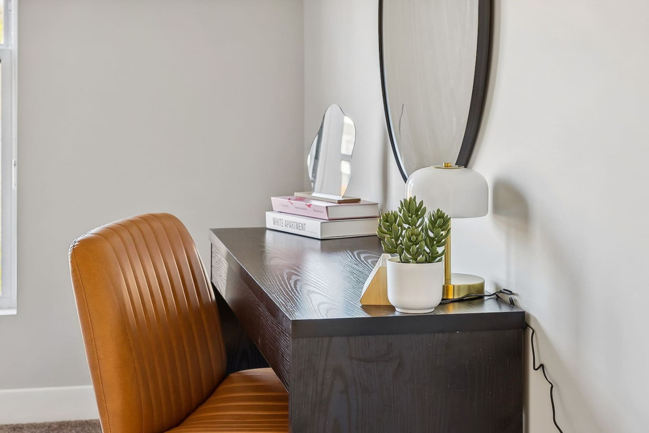 This cozy workspace with warm lighting, and a creative wall display, perfect for productivity.