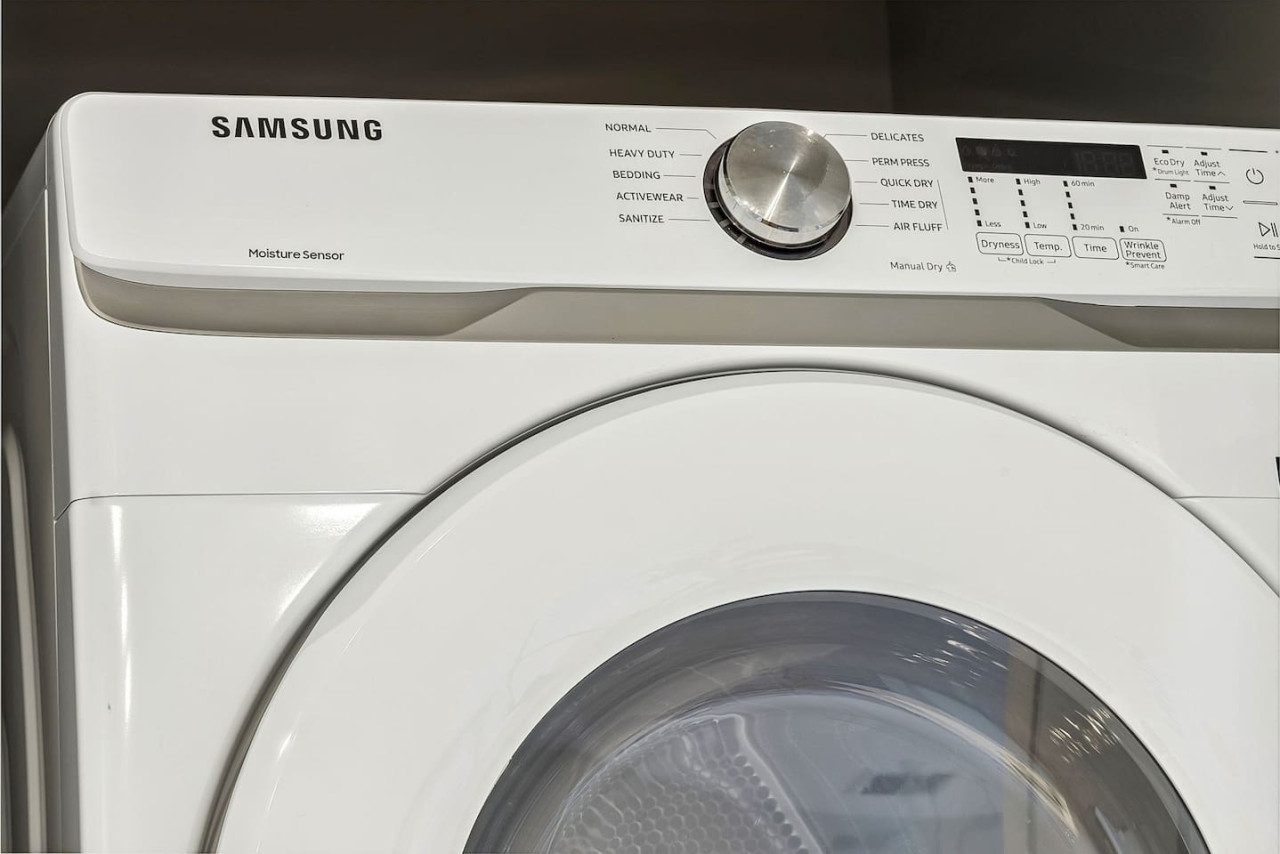 As you step into the laundry room, the modern appliances and ample storage space make it easy to keep things tidy.