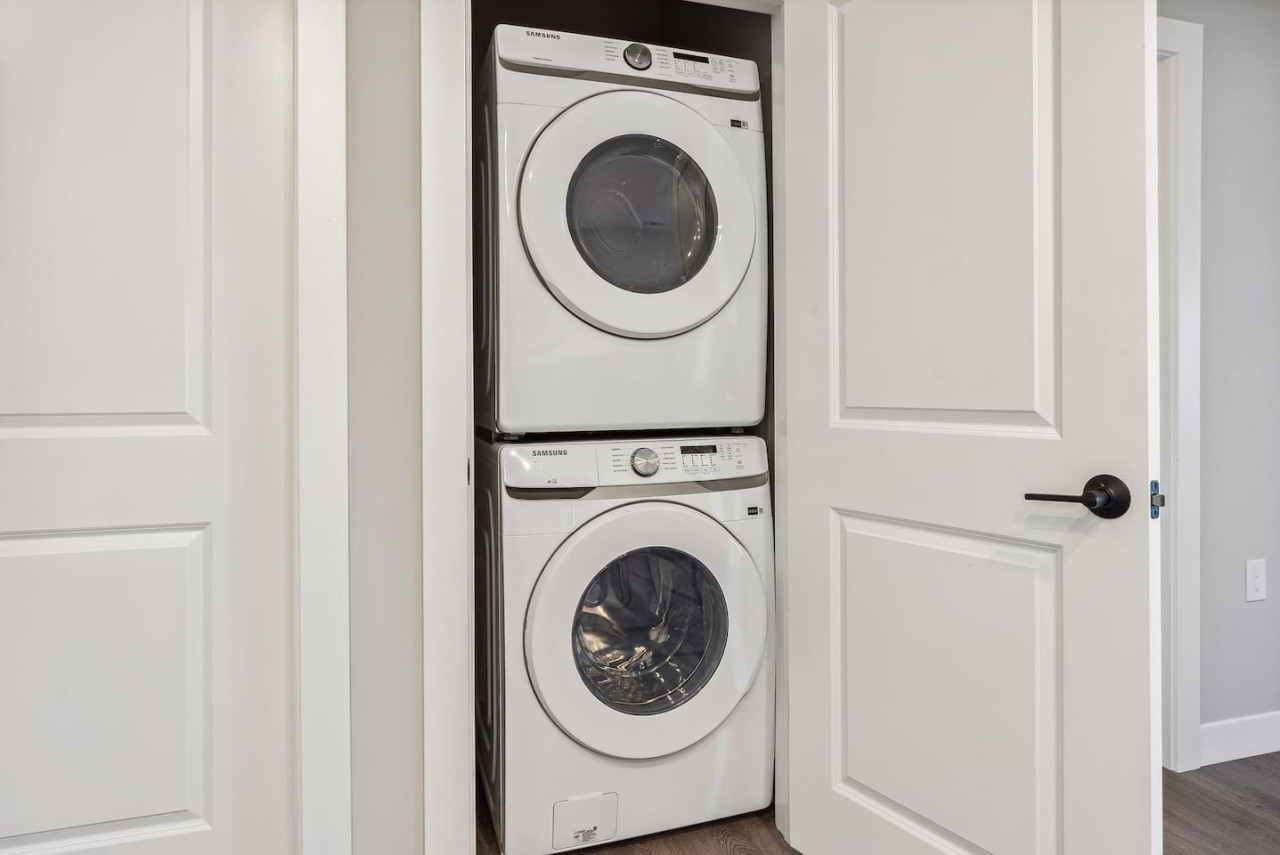 As you step into the laundry room, the modern appliances and ample storage space make it easy to keep things tidy.