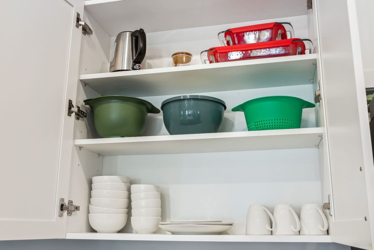 Kitchen cabinets stocked with cooking wares, glassware and silverwares, ideal for mixing up your favorite meals and drinks during your stay.