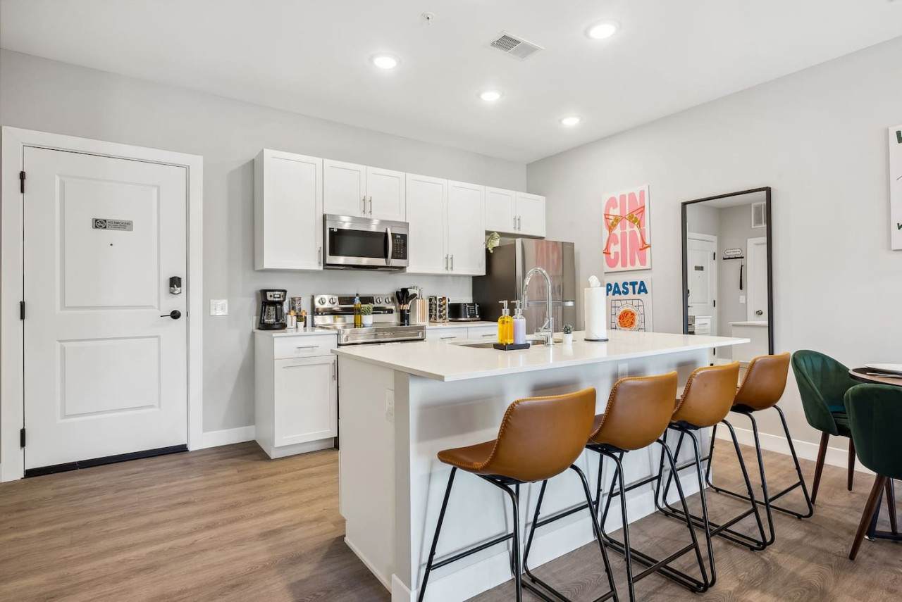 As you approach the home bar, the elegant layout and well-stocked shelves make it the ideal spot to relax.