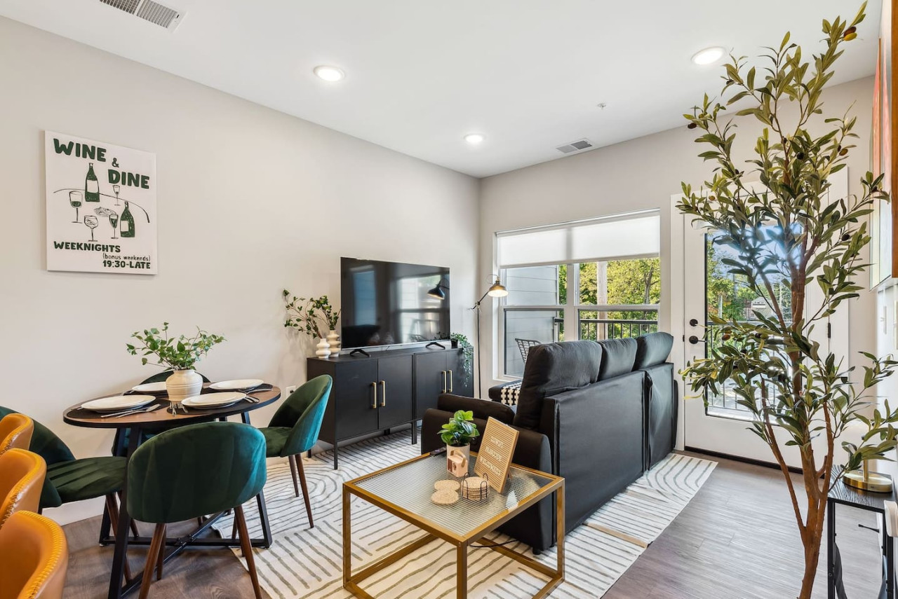 Bright and airy living room with plush seating, a large TV, and tasteful decor, creating the perfect space for relaxation and entertainment.