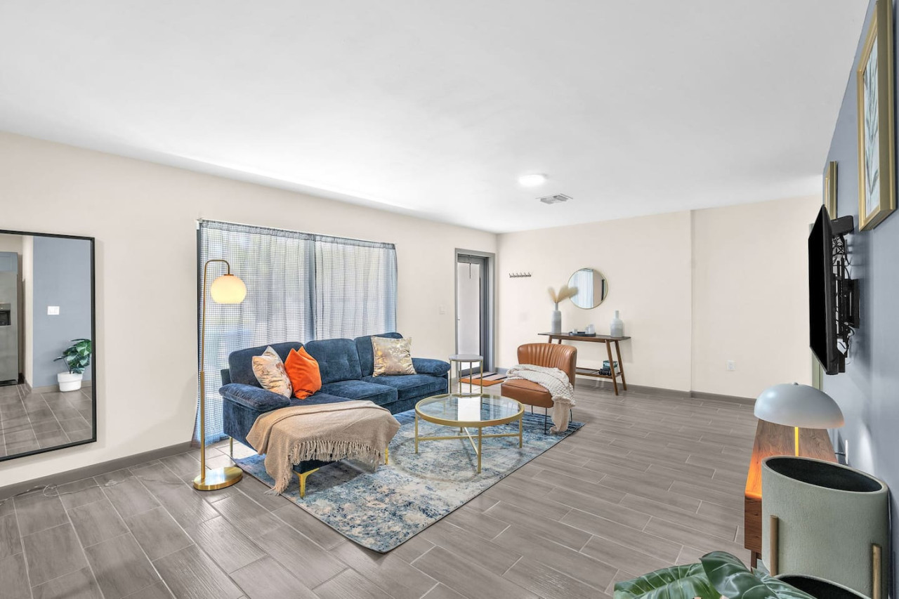 Bright and airy living room with plush seating, a large TV, and tasteful decor, creating the perfect space for relaxation and entertainment.