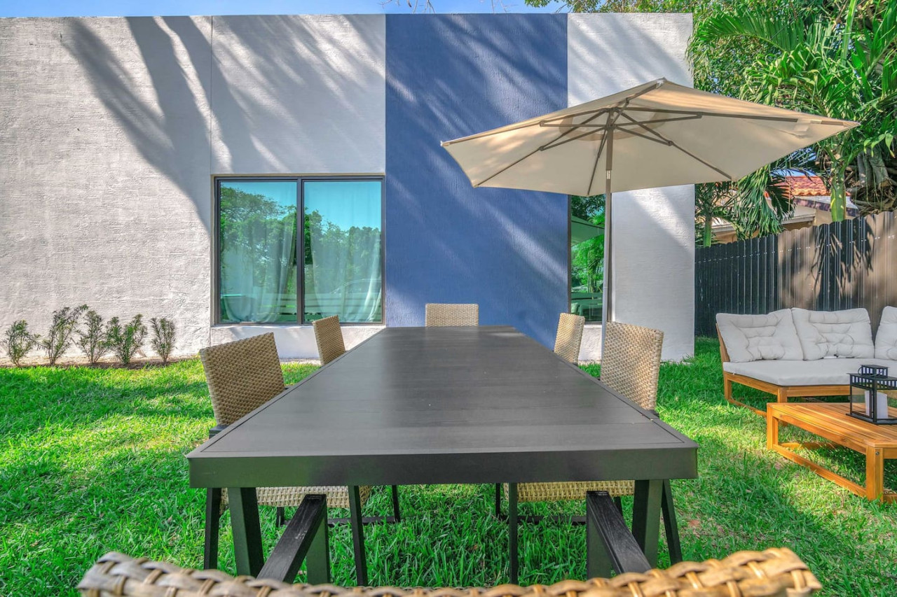 Outdoor dining area with a long table.