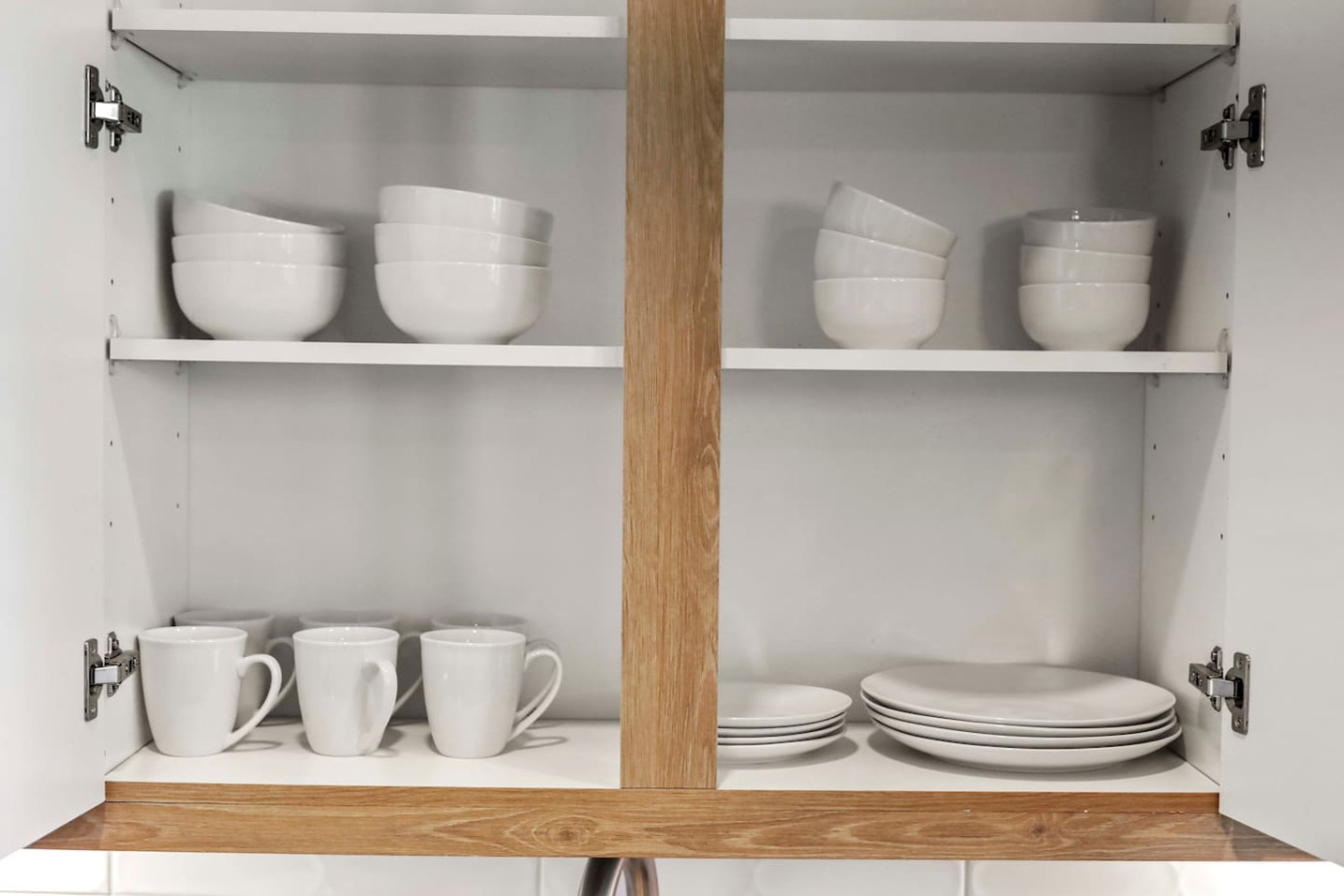 Kitchen cabinets stocked with cooking wares, glassware and silverwares, ideal for mixing up your favorite meals and drinks during your stay.