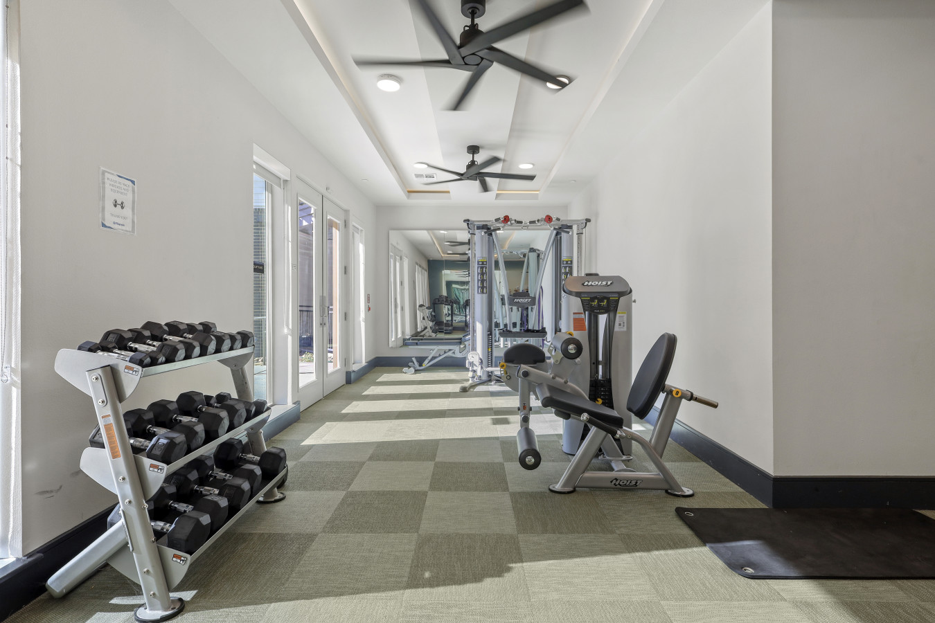 Dedicated space featuring a wide range of dumbbells, benches, and mirrors for strength and resistance training