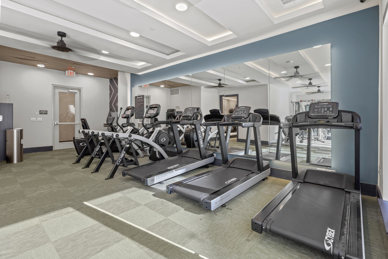 Open floor area with exercise mats, yoga balls, and foam rollers for warm-ups, stretching, or core exercises.