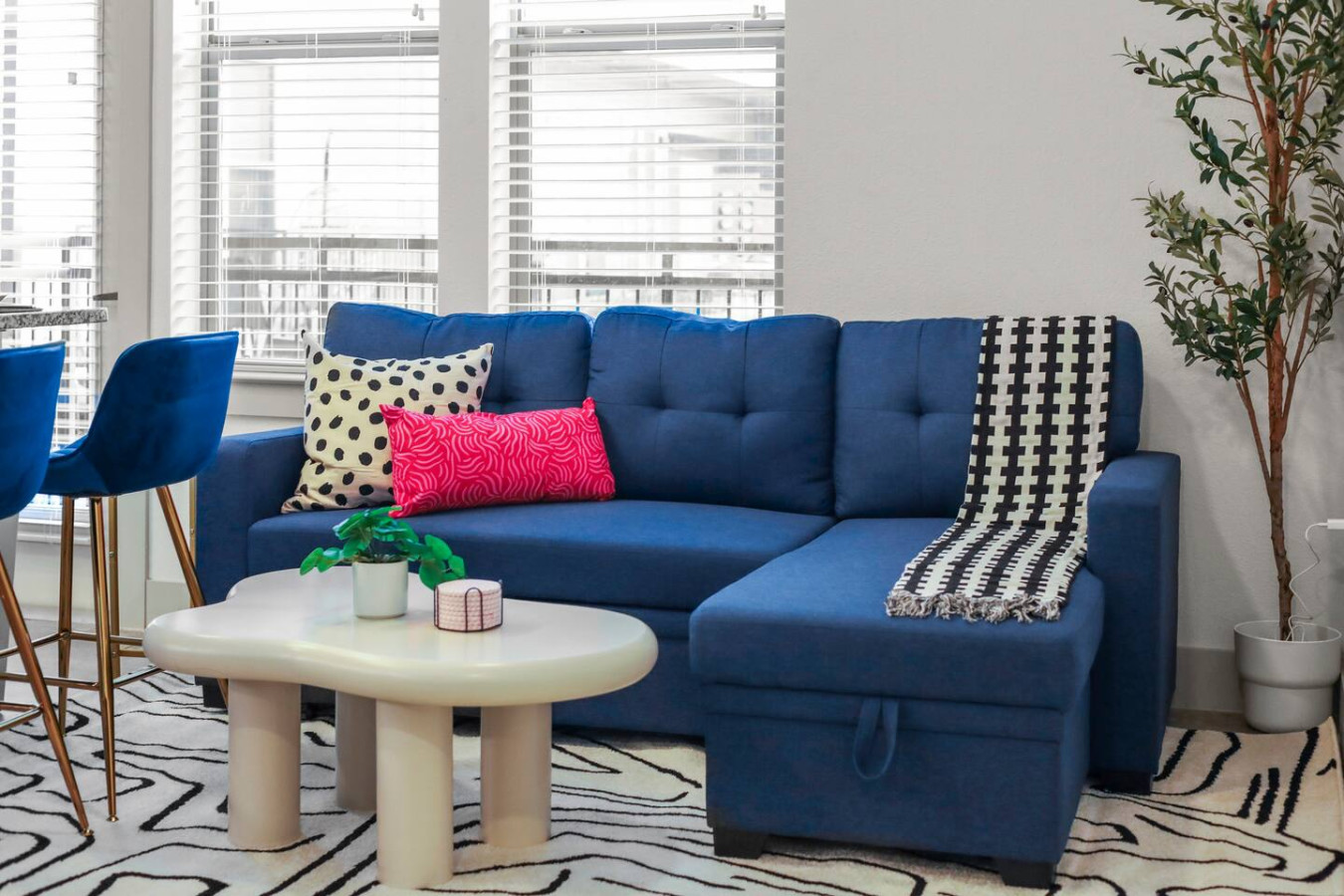 Bright and airy living room with plush seating, a large TV, and tasteful decor, creating the perfect space for relaxation and entertainment.
